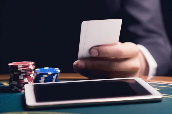 A young woman relaxing with her phone while dynamic casino elements float around her, illustrating the smooth mobile experience offered by the 6363PH app.