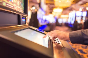 A man focused on his laptop with live stats in the background, highlighting the dedicated sports and gaming features of the 6363PH mobile app.