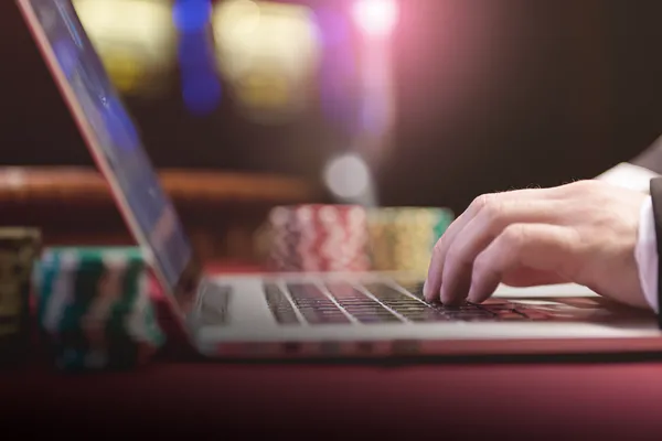 A professional dealer in a tuxedo greeting players at the roulette table, symbolizing the authentic live casino feel at 6363PH.