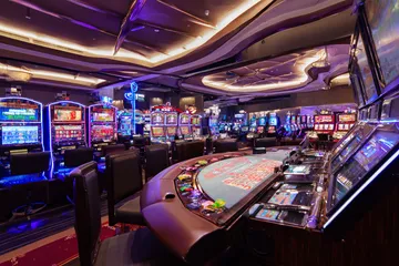 A glowing roulette wheel with cascading chips, symbolizing the engaging live and instant-win games available on 6363PH.