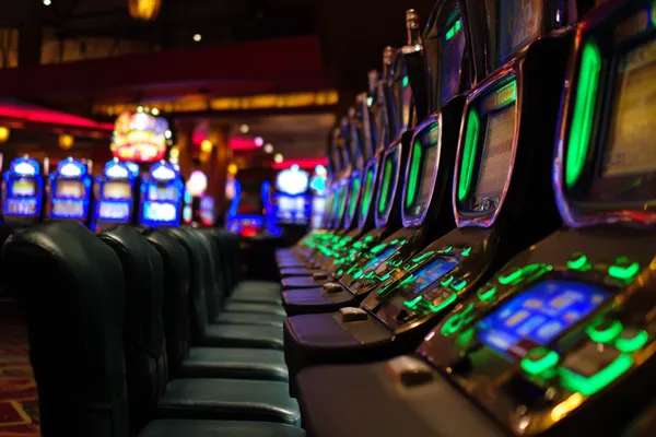 A woman in a luxurious green gown next to an ornate roulette wheel, capturing the upscale casino mood of 6363PH.