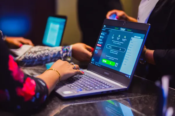 A confident dealer surrounded by casino chips inviting players to access their 6363PH account, reflecting quick and easy login options.
